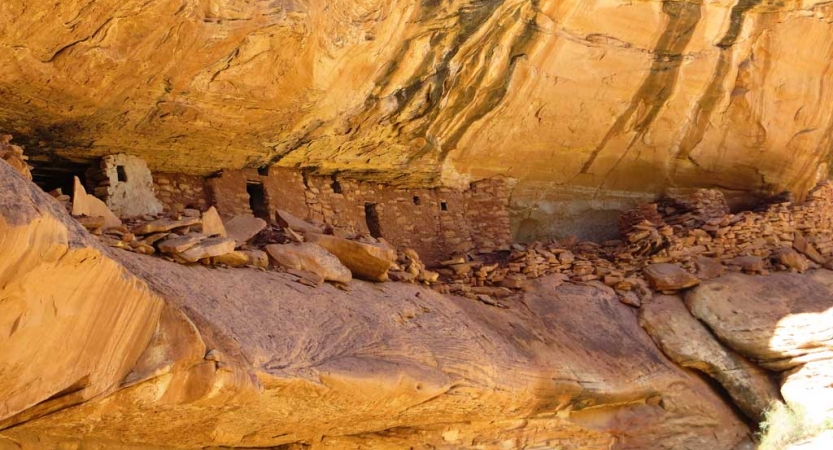 The remains of an ancient dwelling sit in the rock of a canyon